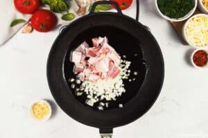 combining onions and bacon in a pan to make Baked Orecchiette with Spinach
