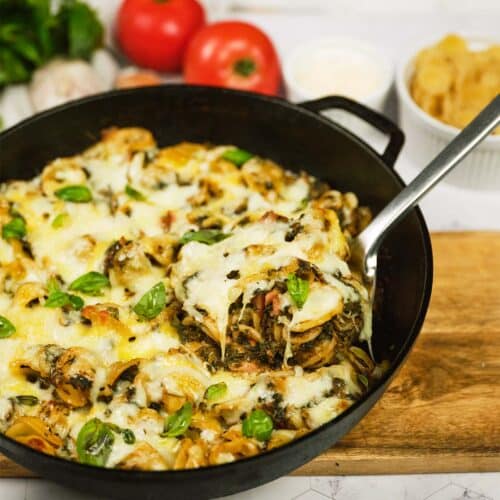 spoon scooping a serving of Baked Orecchiette with Spinach from a pan