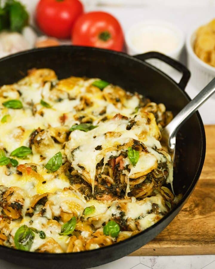 spoon scooping a serving of Baked Orecchiette with Spinach from a pan